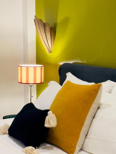 a bedroom with a bed with a pillow and a lamp at Podere Gattabigia in Lastra a Signa