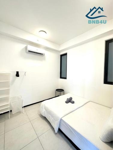 a white room with two beds and a window at Urban Suites @ George Town Penang by BNB4U in George Town