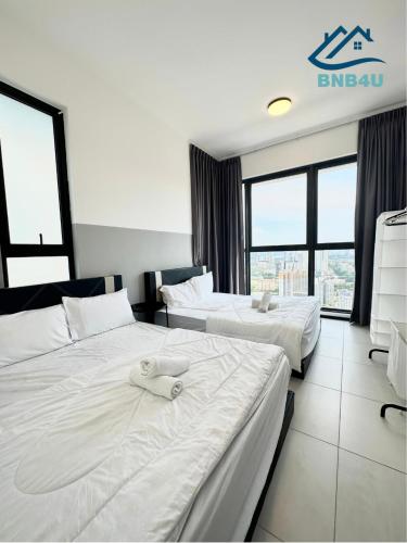 a hotel room with two beds with towels on them at Urban Suites @ George Town Penang by BNB4U in George Town