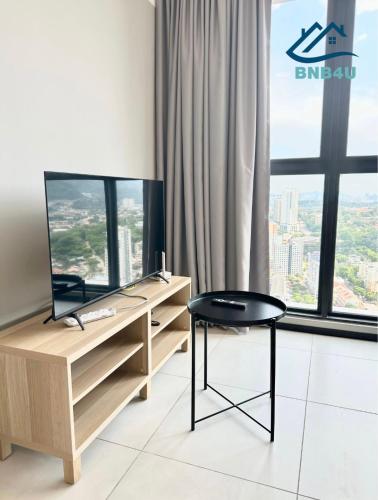 a desk and chair in a room with a window at Urban Suites @ George Town Penang by BNB4U in George Town