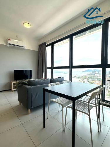a living room with a couch and a table and chairs at Urban Suites @ George Town Penang by BNB4U in George Town