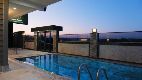 a swimming pool on the roof of a building at KRABİ APART in Antalya