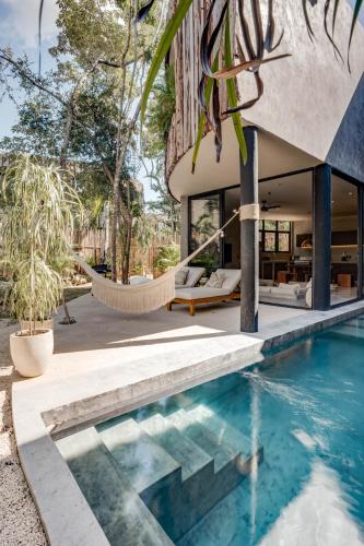 an external view of a house with a swimming pool at Esencia Villas Tulum Priv Pool Concierge in Tulum