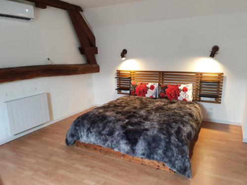 a bedroom with a large bed in a room at Maison de campagne in Amponville