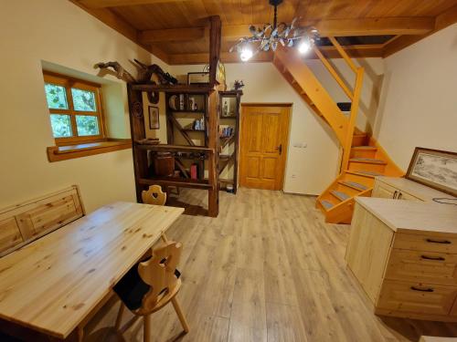 a dining room with a wooden table and stairs at Stari mlin Franja/Old Mill Franja in Šentrupert