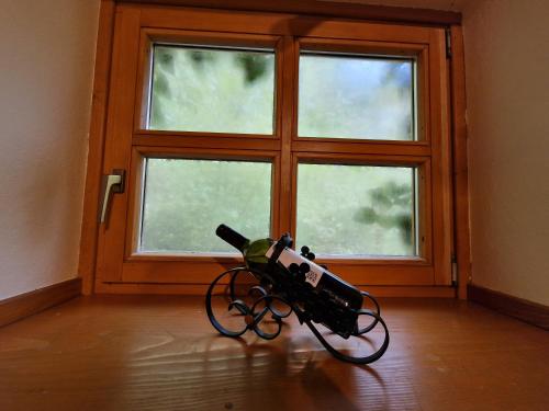 a camera on the floor in front of a window at Stari mlin Franja/Old Mill Franja in Šentrupert