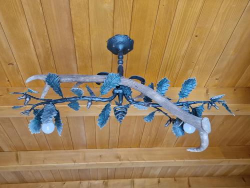 a chandelier hanging from a wooden ceiling at Stari mlin Franja/Old Mill Franja in Šentrupert