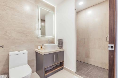 ein Badezimmer mit einer weißen Toilette und einem Waschbecken in der Unterkunft DellaTerra-1-PV 1st Floor in Bucerías