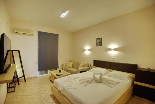 a bedroom with a bed with a bow on it at Studios Nelli Alonissos in Patitiri