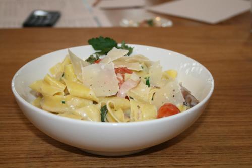 a bowl of pasta with meat and vegetables on a table at Interlaken Youth Hostel in Interlaken