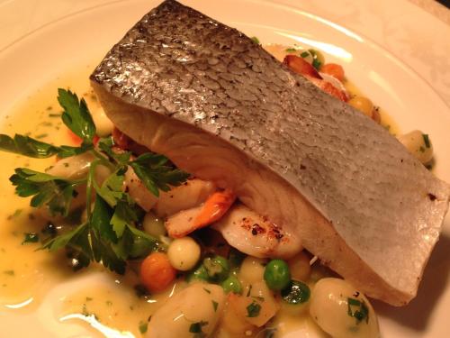 a plate of food with a piece of fish with vegetables at Callander Meadows in Callander