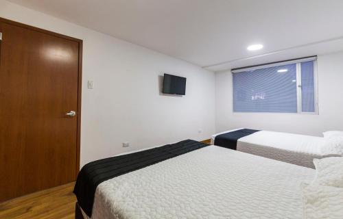 Postel nebo postele na pokoji v ubytování Hotel Casa Botero 201