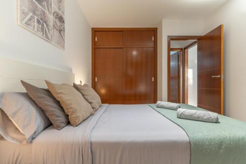 a bedroom with a large bed with pillows on it at Casa More Alcalá Center in Alcalá