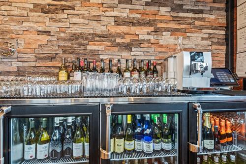 a bar with many bottles of wine and glasses at Cobblestone Hotel & Suites - Cullman in Cullman