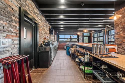 a room with a brick wall and a counter in a restaurant at Cobblestone Hotel & Suites - Cullman in Cullman
