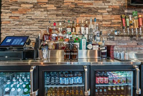 a bar with a lot of bottles of alcohol at Cobblestone Hotel & Suites - Cullman in Cullman