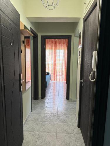 a hallway with a hallway leading to a room at Calypso Seaside Apartment in Paleo Tsifliki