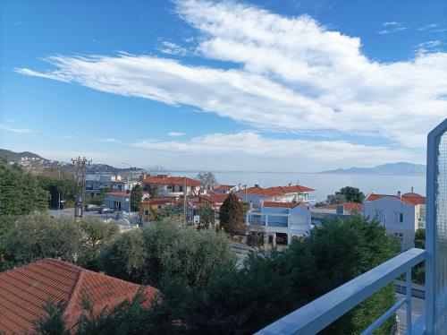 a view from a balcony of a city with buildings at Calypso Seaside Apartment in Paleo Tsifliki