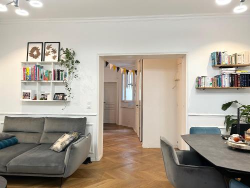 a living room with a couch and a table at Paris 16 lux and cozy 2 bedroom in Paris
