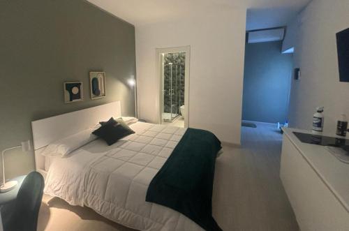 a bedroom with a white bed and a sink at Narciso boutique apartment in Acireale