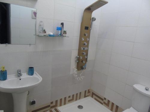 a white bathroom with a sink and a toilet at Abidjan Cocody 3-Bed Apt - Sleeps 6 in Cocody