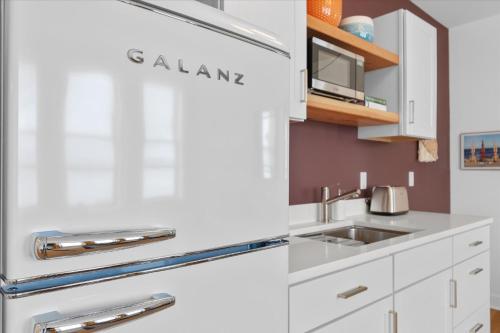 a kitchen with white cabinets and a sink at Norblad Hotel in Astoria, Oregon
