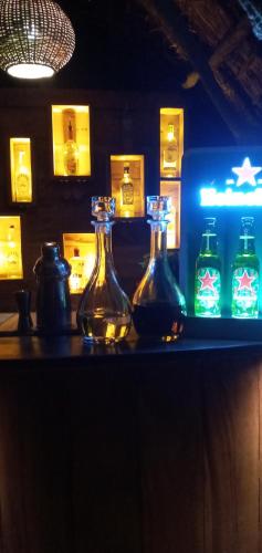 two bottles of water sitting on a counter in a bar at Cinnabar Resort in Tangalle