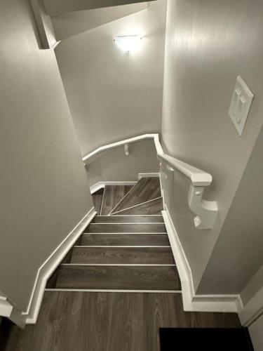 a staircase in a building with a stair case at Private Luxury Suite Near West Edmonton Mall in Edmonton