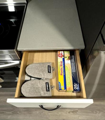 a box with two controllers and two books in it at Private Luxury Suite Near West Edmonton Mall in Edmonton