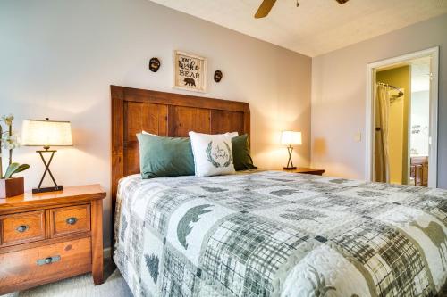 a bedroom with a bed and a dresser and lamps at Secluded Sevierville Condo with Hot Tub and Mtn Views! in Sevierville