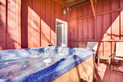 a large bath tub in a room with wooden walls at Secluded Sevierville Condo with Hot Tub and Mtn Views! in Sevierville