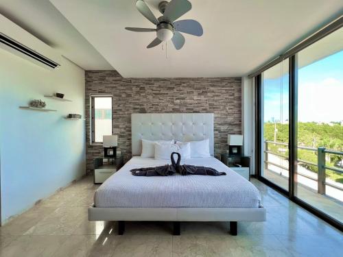 a bedroom with a bed and a ceiling fan at Spacious Penthouse w/ Private Pool & Maid Service in Puerto Morelos