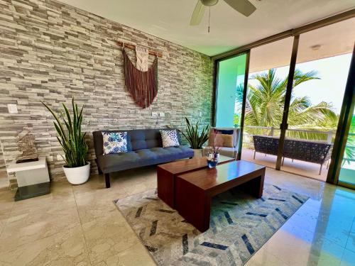 a living room with a couch and a table at Spacious Penthouse w/ Private Pool & Maid Service in Puerto Morelos