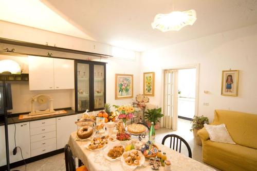 a kitchen with a table with food on it at B&B Vigna La Corte in Alessano