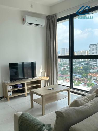 a living room with a couch and a tv at Urban Suites @ George Town Penang by BNB4U in George Town