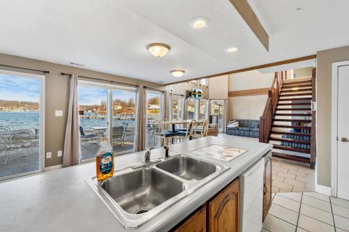 a kitchen with a sink and a view of the water at Lazy Gator House- Sleep 20- Bachelor Parties Welcome in Lake Ozark