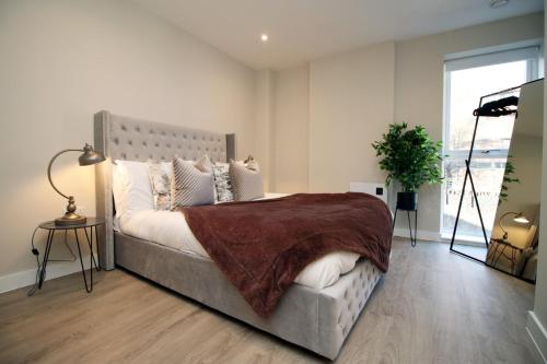 a bedroom with a large bed and a large window at Casablanca 4 - Cardiff Bay - 2 Bed Apartment in Cardiff