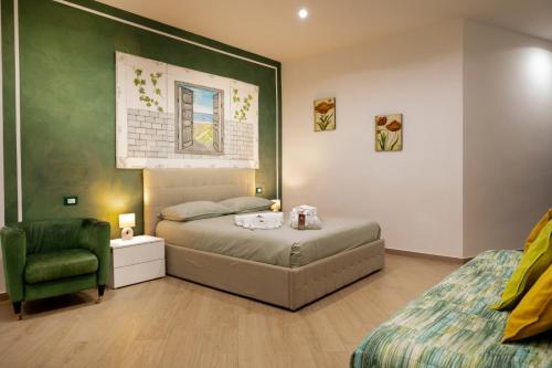 a bedroom with a bed and a green wall at Domus Cuomo B&B in Nocera Inferiore