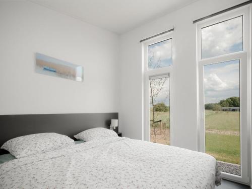 Habitación blanca con cama y ventana en Water Resort Oosterschelde 2, en Wemeldinge