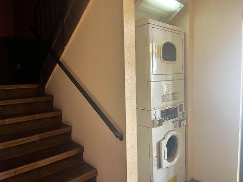 a washing machine next to a staircase in a room at Motel 6 Deming, NM in Deming