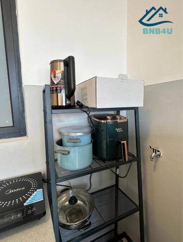 a shelf with pots and pans on it in a room at Urban Suites @ George Town Penang by BNB4U in George Town