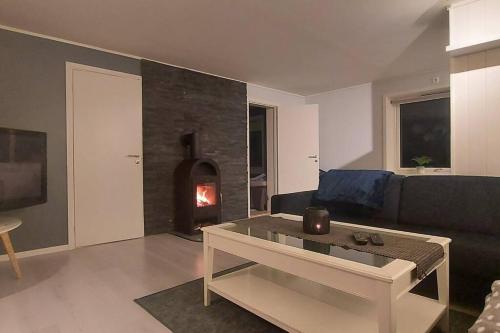 a living room with a couch and a fire place at 3-roms leilighet, innsjekk uten vert. Egen inngang in Ålesund