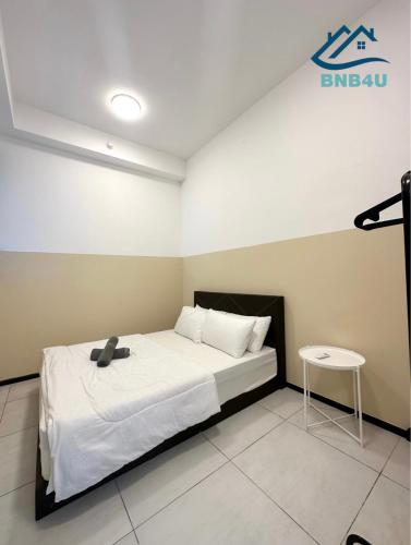 a bedroom with a bed and a table in it at Urban Suites @ George Town Penang by BNB4U in George Town