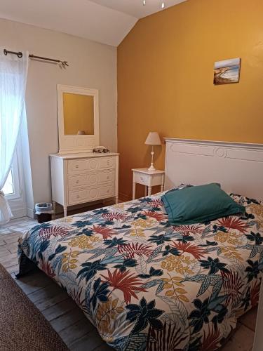 a bedroom with a bed and a dresser at Le Jardin Des Cèdres in Lavaur