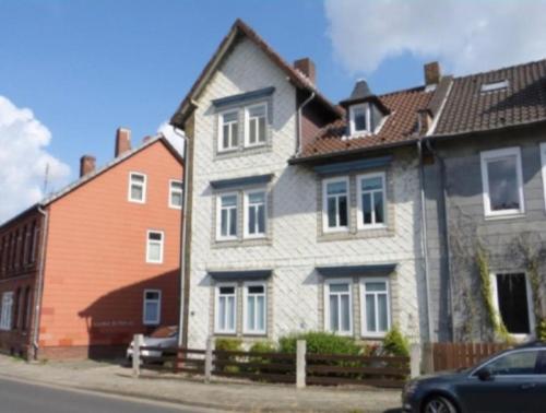 a gray and white house with a orange house at Drei Linden Jasper in Wolfenbüttel