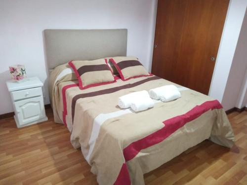 a bedroom with two beds with towels on them at departamento Euge in Olavarría