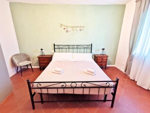 a bedroom with a bed with two towels on it at CASA ARYA - Independent House - Near the Walls in Lucca