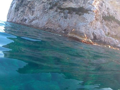 a large body of water next to a cliff at Bilocale panoramico “Lo sguardo” in Massa Lubrense