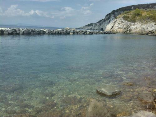 a large body of water with rocks in it at Bilocale panoramico “Lo sguardo” in Massa Lubrense