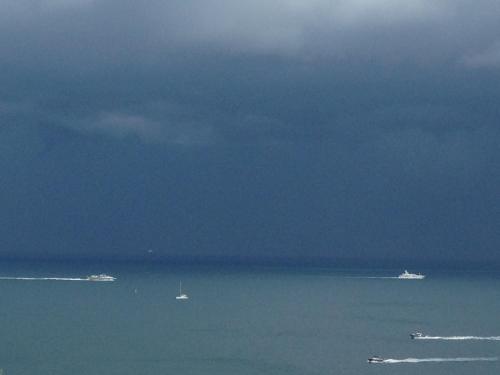 a view of the ocean with boats in the water at Bilocale panoramico “Lo sguardo” in Massa Lubrense